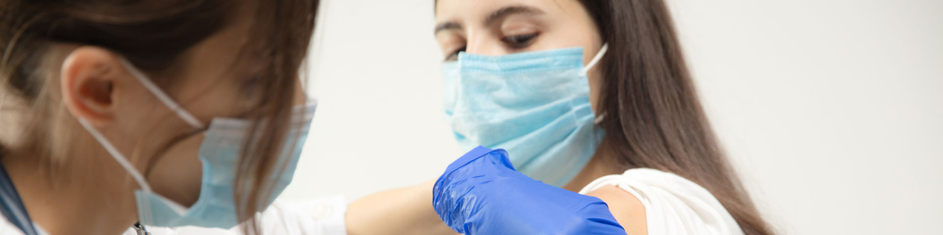 Adolescent receiving a vaccine